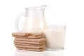 Jug and glass of milk with grain crispbreads isolated on white background Royalty Free Stock Photo