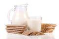 Jug and glass of milk with grain crispbreads isolated on white background Royalty Free Stock Photo