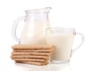 Jug and glass of milk with stack of grain crispbreads isolated on white background Royalty Free Stock Photo