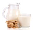 Jug and glass of milk with stack of grain crispbreads isolated on white background Royalty Free Stock Photo