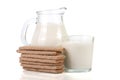 Jug and glass of milk with stack of grain crispbreads on white background Royalty Free Stock Photo
