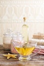 Jug of golden liquid soap on wooden table Royalty Free Stock Photo