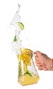 Jug with lemonade splash in hand Royalty Free Stock Photo