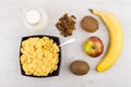 Jug of milk, bowl with corn flakes and fruits Royalty Free Stock Photo