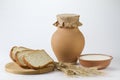 Jug of milk with freshly baked white bread and wheat ears Royalty Free Stock Photo