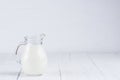 Jug of milk on white wooden table Royalty Free Stock Photo