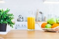 Jug of orange juice and fruit on the kitchen table Royalty Free Stock Photo