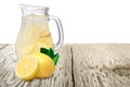 Jug or pitcher of lemonade with lemons on foreground standin on Royalty Free Stock Photo