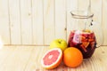 A jug of refreshing sangria with fruits on wooden background