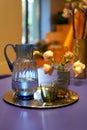 Jug on the tray on very peri table with two glasses Royalty Free Stock Photo