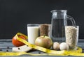 Jug of water ,tomato, Apple, glass of cereal, glass of buckwheat and oat flakes, glass of milk, 2 raw eggs, yellow measuring tape