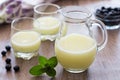 A jug of whey with blueberries in the background Royalty Free Stock Photo