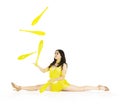 A juggler, a circus performer, a young woman in a yellow suit with dark hair, performs on a white background Royalty Free Stock Photo