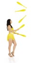 A juggler, a circus performer, a young woman in a yellow suit with dark hair, performs on a white background Royalty Free Stock Photo