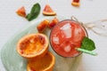 Juice of blood red oranges, fresh fruit, on green mint table Royalty Free Stock Photo