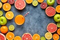 Juice with citrus fruit, apple, grapefruit on blue background. Top view, selective focus. Detox, dieting, clean eating