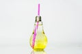 Juice in a clear glass bottle with a white and pink tube, placed on an isolated white background, infused water and healthy drink Royalty Free Stock Photo