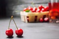 Juice or compote with cherries. fresh ripe red cherry in a basket on a gray concrete background, summer berry, summer drink Royalty Free Stock Photo