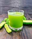 Juice cucumber in glassful on dark board