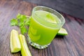 Juice cucumber in glassful with vegetables on dark board Royalty Free Stock Photo