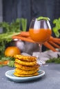 Juice from fresh carrots and grapefruit in a glass and fragrant pancakes for breakfast. vitamin drink for a healthy diet. Vitamins