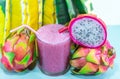 Juice in glass cup and fresh fruit and twigs of pitaya (Hylocereus polyrhizus