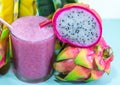 Juice in glass cup and fresh fruit and twigs of pitaya (Hylocereus polyrhizus