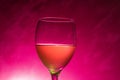 Juice glass with pink background Royalty Free Stock Photo