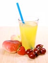 Juice in glass with platt peach, cherries, strawberry Royalty Free Stock Photo