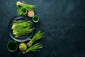 The juice from the green sprouted wheat, and wheat grains. On a black background. Micro Green. Healthy food. Top view. Free space Royalty Free Stock Photo