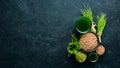 The juice from the green sprouted wheat, and wheat grains. On a black background. Micro Green. Healthy food. Top view. Free space Royalty Free Stock Photo