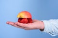 Juice ingredients. Fresh organic harvest of ripe fruit berries. Male hand with strawberries and half of apple blue Royalty Free Stock Photo