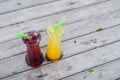 Juice mix berry, mango and passion fruit drink in tall glass with straw green color on wooden Royalty Free Stock Photo