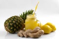 Juicing raw fruits and vegetables and juice extractor recipes concept with pineapple, lemon and ginger, the ingredients for a
