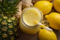 Juicing raw fruits and vegetables and juice extractor recipes concept with pineapple, lemon and ginger, the ingredients for a