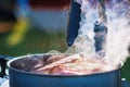 Juicy Angus steak fried in iron cast pan with smoke and Tongs on blurred background Royalty Free Stock Photo