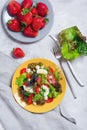 Juicy appetizer with crispy salad, strawberries, cheese and basil, and egg.