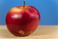 Juicy apple isoloated on blue background on the desk