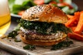 Juicy Beef burger with crispy kale, sweet potato fries and beer