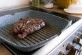 Juicy beef meat steak cooking on griddle pan at professional kitchen. Prime steak frying at grill. Delicious, modern Royalty Free Stock Photo