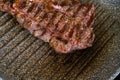 Juicy beef meat steak cooking on griddle pan at professional kitchen. Prime steak frying at grill. Delicious, modern Royalty Free Stock Photo