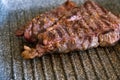 Juicy beef meat steak cooking on griddle pan at professional kitchen. Prime steak frying at grill. Delicious, modern Royalty Free Stock Photo