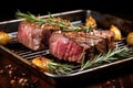 juicy beef roast with roasted garlic cloves and rosemary twigs on a metal tray