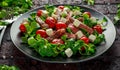 Juicy Beef Sirloin Steak Salad with roasted tomatoes, feta cheese and green vegetables in a black plate. healthy food Royalty Free Stock Photo