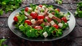 Juicy Beef Sirloin Steak Salad with roasted tomatoes, feta cheese and green vegetables in a black plate. healthy food Royalty Free Stock Photo