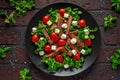 Juicy Beef Sirloin Steak Salad with roasted tomatoes, feta cheese and green vegetables in a black plate. healthy food Royalty Free Stock Photo