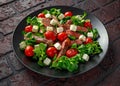 Juicy Beef Sirloin Steak Salad with roasted tomatoes, feta cheese and green vegetables in a black plate. healthy food Royalty Free Stock Photo