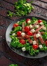 Juicy Beef Sirloin Steak Salad with roasted tomatoes, feta cheese and green vegetables in a black plate. healthy food Royalty Free Stock Photo