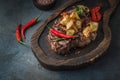 Juicy beef steak served on wooden board with crispy potatoe chips and chilli Royalty Free Stock Photo