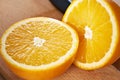 Juicy bisected oranges closeup on wooden board